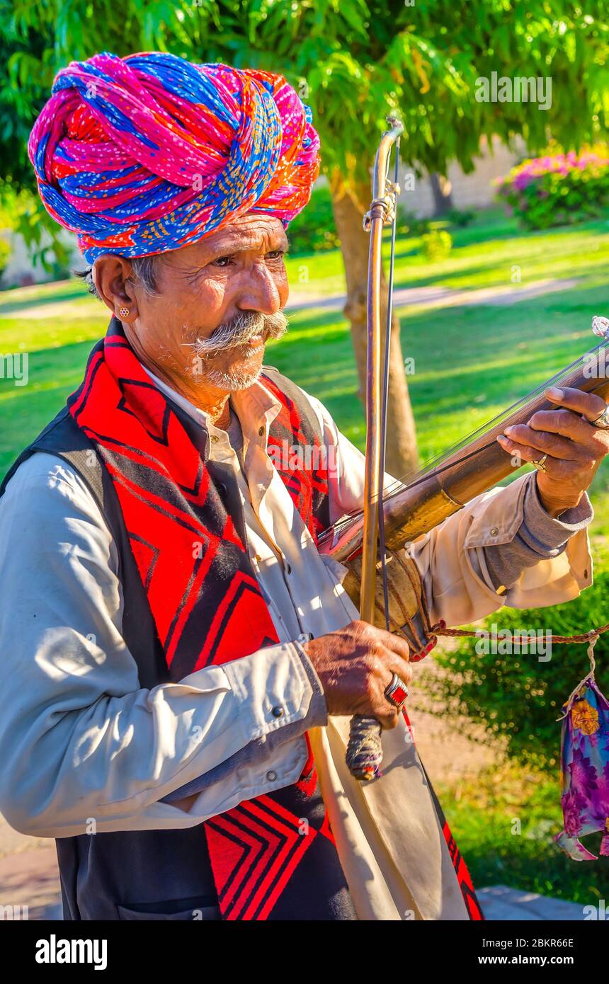 JODHPUR, INDIA – DIC. 02, 2019: Músico nómada no identificado con turban de colores tocando Ravanahatha (el predecesor de la actual Violin). Foto de stock