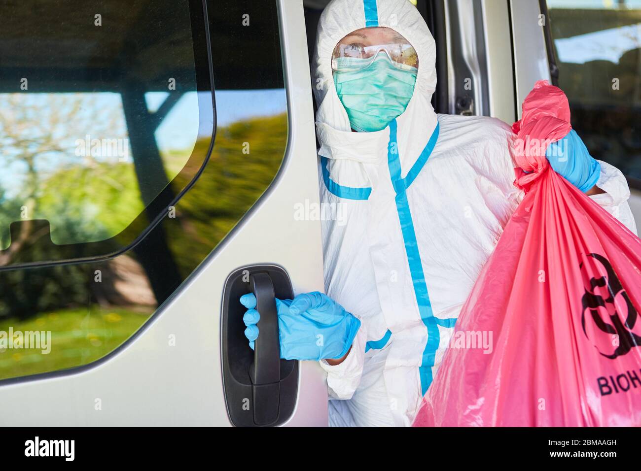 Transporte y eliminación de residuos especiales de la clínica por personal  de limpieza en ropa protectora durante la pandemia del coronavirus  Fotografía de stock - Alamy