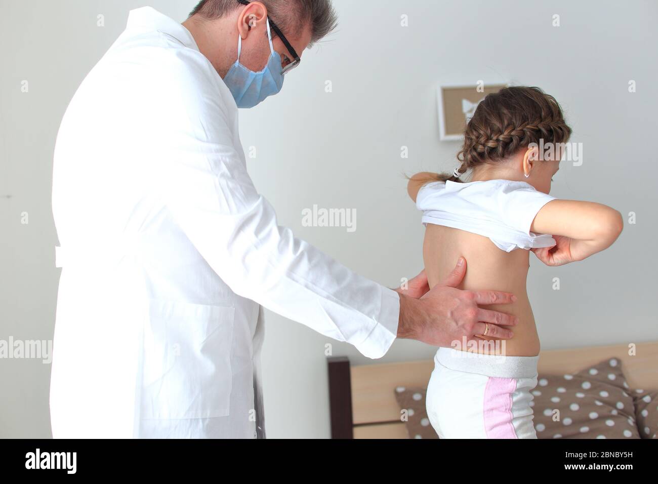 El médico examina a una niña en casa. Foto de stock