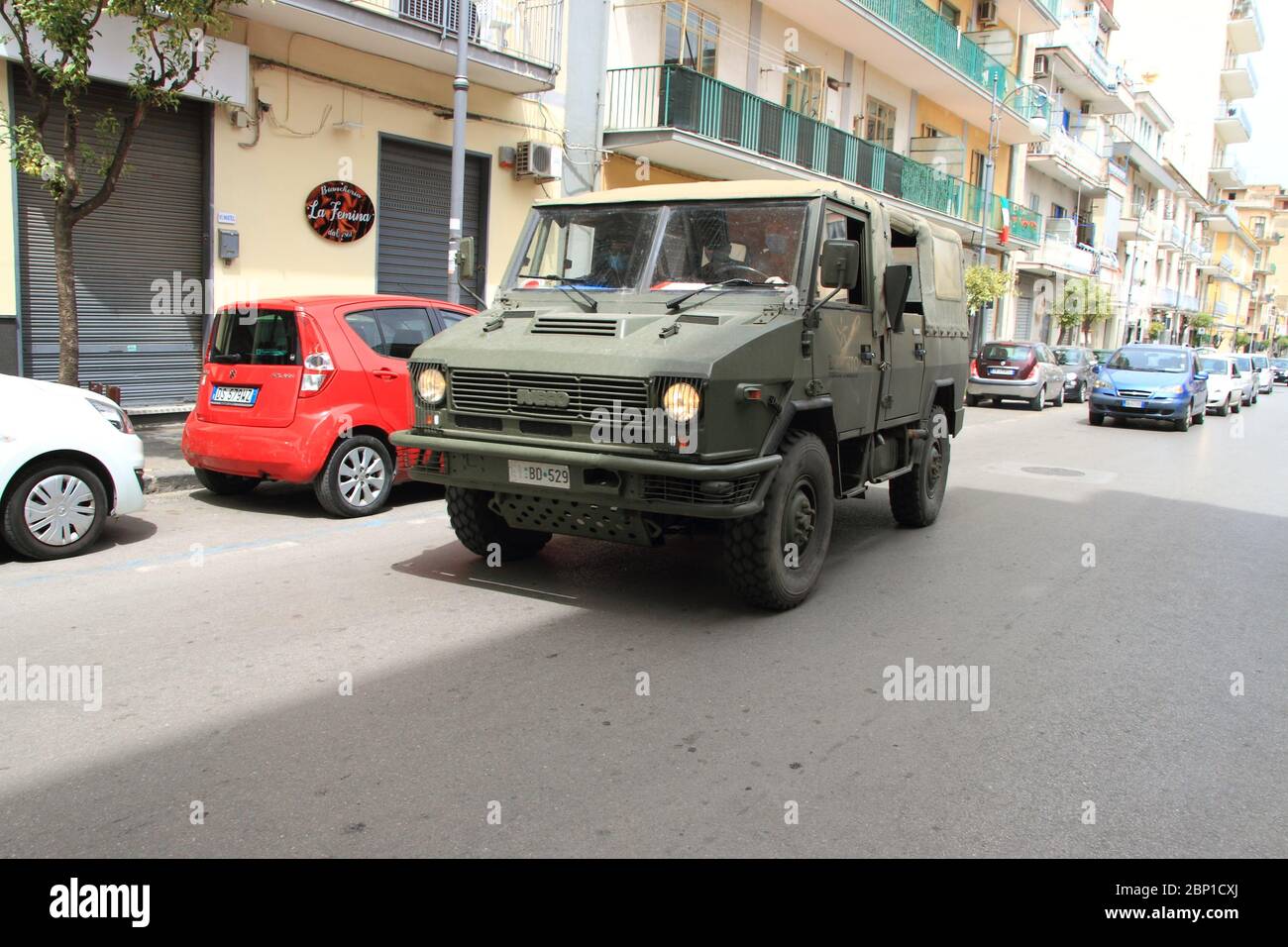Un vehículo militar del ejército italiano alrededor del centro de la ciudad para una acción para controlar el cumplimiento de las reglas de la distancia social durante la fase 2. Foto de stock