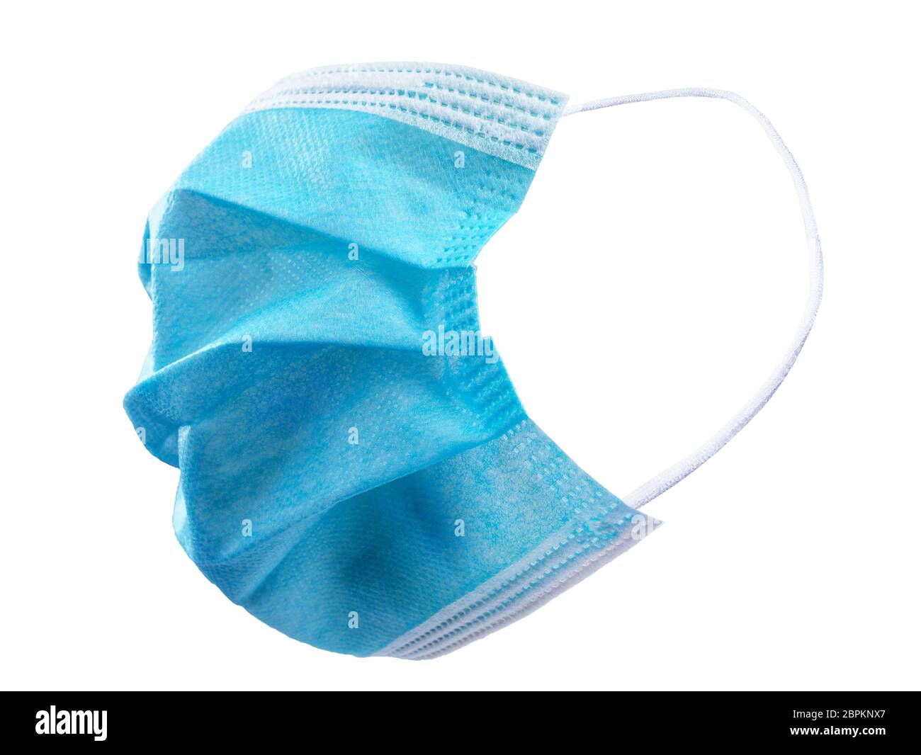 Vista lateral de la máscara quirúrgica aislada con correas de goma para el oído para cubrir la boca y la nariz para proteger la cara del virus Foto de stock