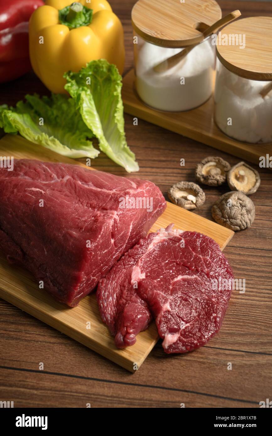 Carne cruda con fondo de mesa de madera, fotografía de la vida. Foto de stock