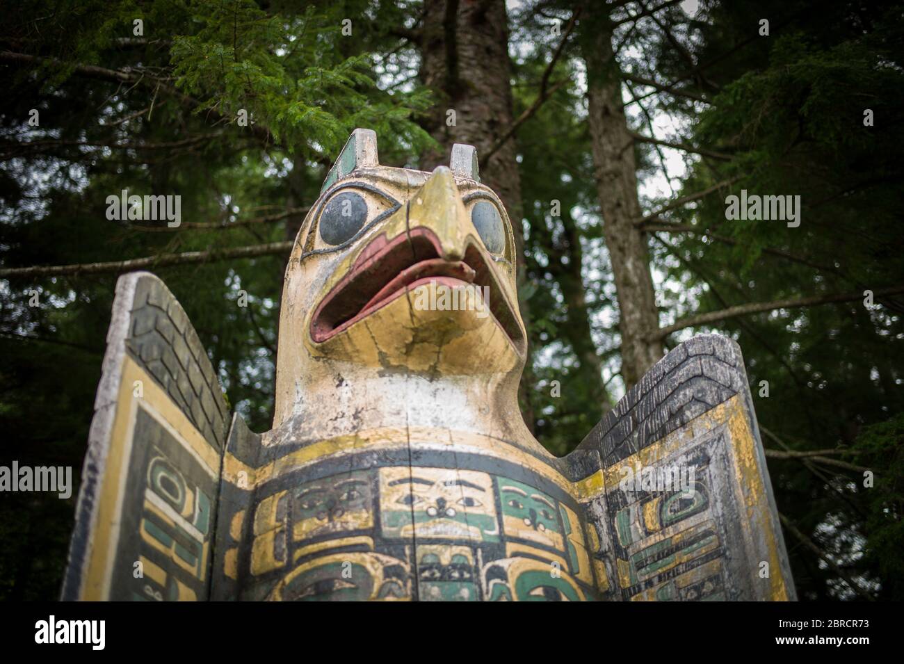 Totem Bight State Historical Park, Ketchikan, Alaska, EE.UU., muestra réplicas y postes de tótem nativos americanos restaurados incluyendo marcador de tumba de águila Foto de stock