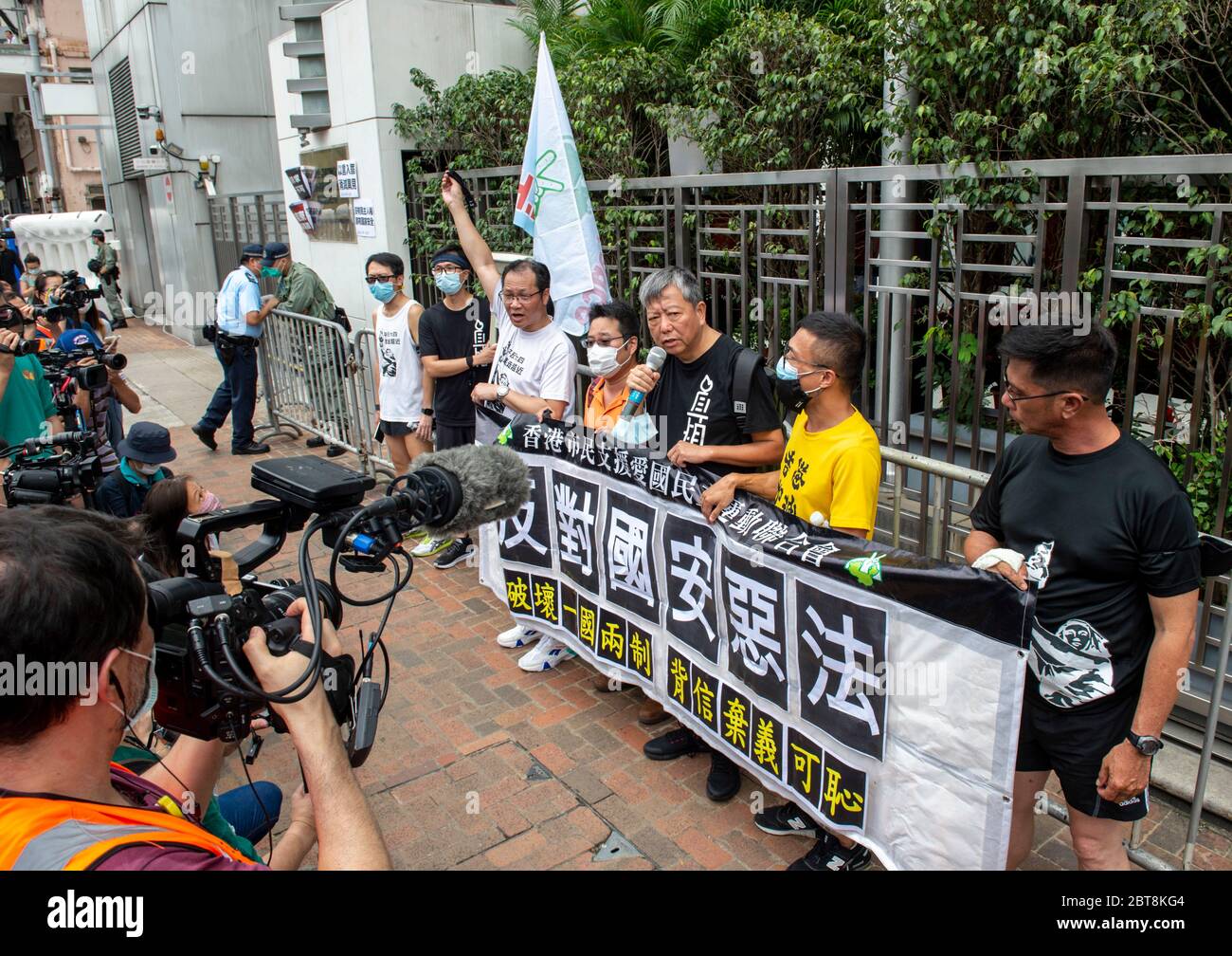 HONG KONG, Hong KONG RAE, CHINA: 24 DE MAYO de 2020.con este evento del 4 de junio de este año prohibido, la gente participa en una carrera de 10km para conmemorar el 31º aniversario del Movimiento Democrático en China 1989 que terminó con el incidente de la Plaza de Tiananmen. LA carrera toma lugares de importancia para la lucha por la democracia en Hong Kong.LEE CHEUK-YAN (con micrófono), ex legislador y uno de los detenidos "Democracia 15", habla fuera de la Oficina de enlace del Gobierno Popular Central en la RAE de Hong Kong, Sai Yin Pun. Richard 15 Tsoi se une a él (L) Alamy Live News/Jayne Russell Foto de stock