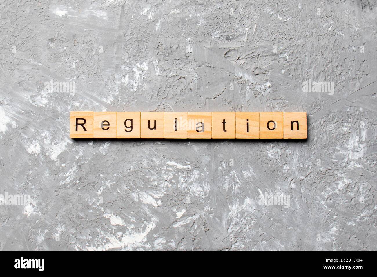 Reglamento palabra escrita sobre un bloque de madera. Reglamento texto en tabla, concepto. Foto de stock