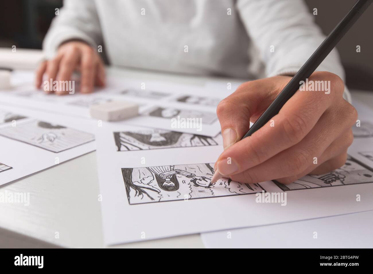 Artista ilustrador dibuja un guión gráfico para la película. El animador crea croquis para la caricatura. Foto de stock