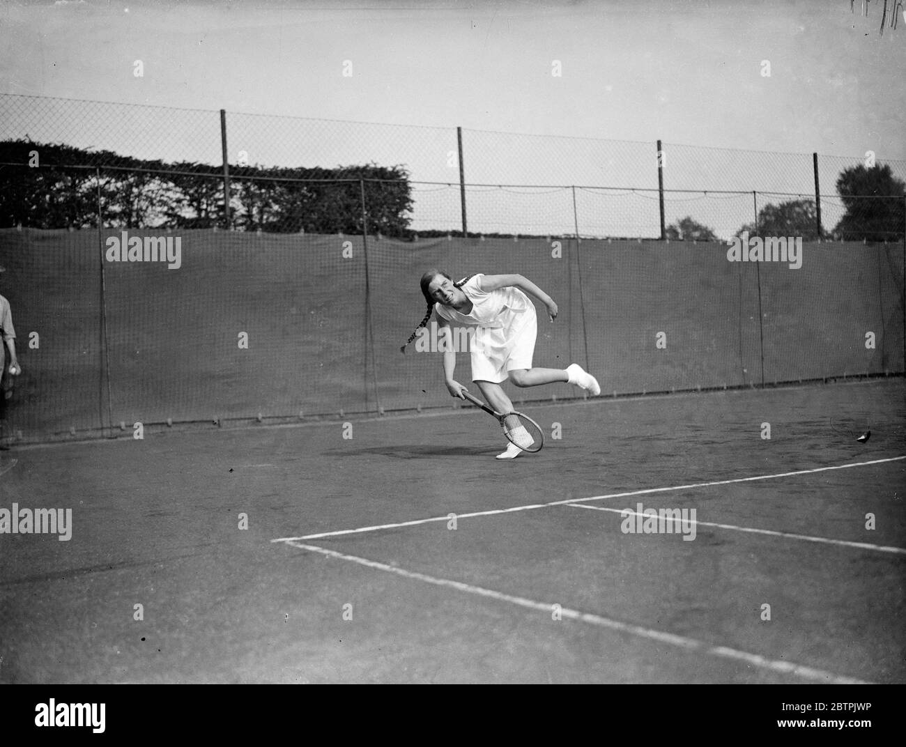 Plaits en Wimbledon . Miss B N Ronaldson , que lleva largas trenzas, en juego en el Campeonato de Tenis de césped Júnior, Wimbledon . 12 de septiembre de 1935 Foto de stock