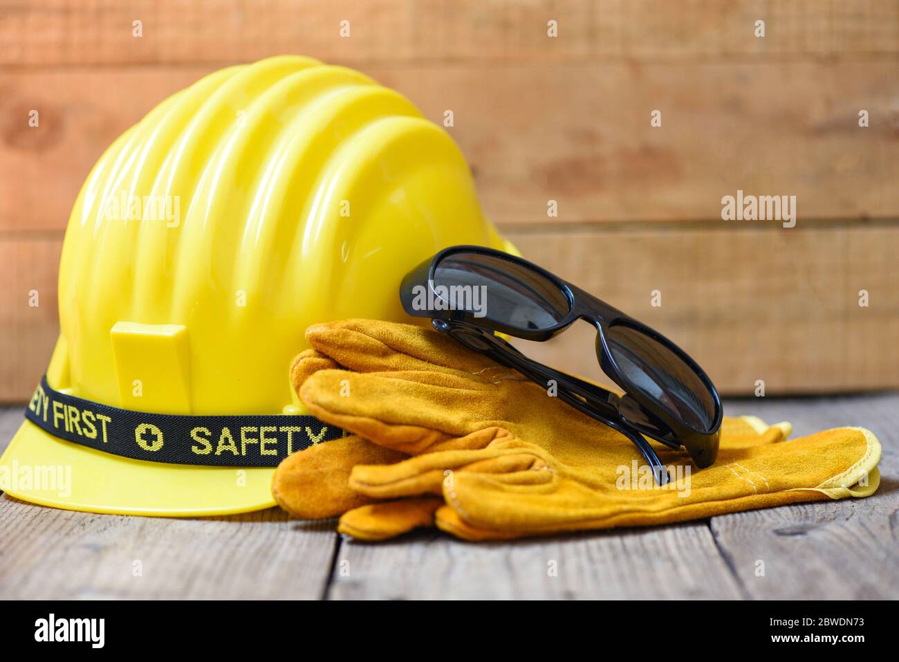 Equipo de seguridad construcción estándar seguridad / ropa de trabajo de  protección industrial herramienta con sombrero amarillo casco de seguridad  gafas y guantes en madera backgroun Fotografía de stock - Alamy