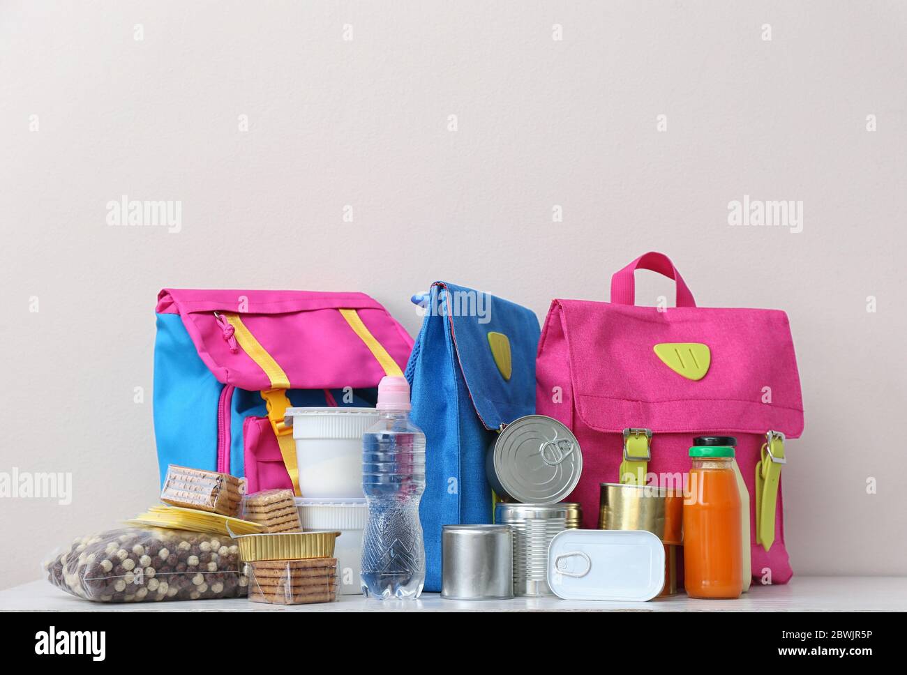 Bolsa escolar con diferentes productos sobre la mesa. Concepto de programa  de comida de mochila Fotografía de stock - Alamy