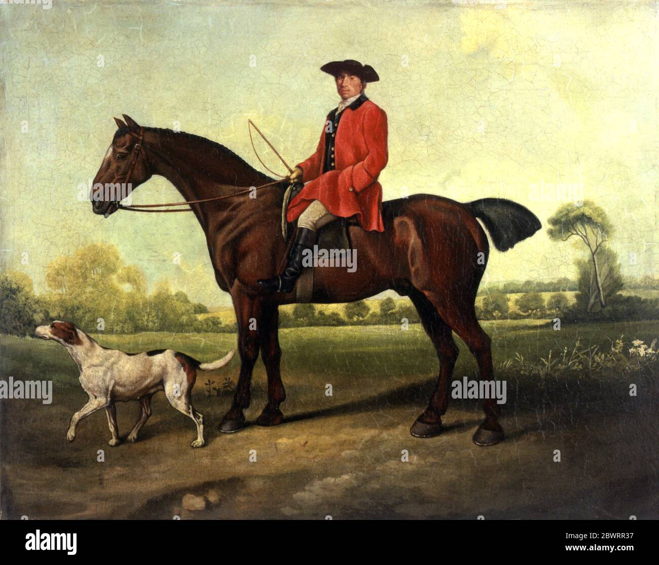 Hombre en abrigo rojo sobre caballo en el paisaje por Bob Venables Foto de stock