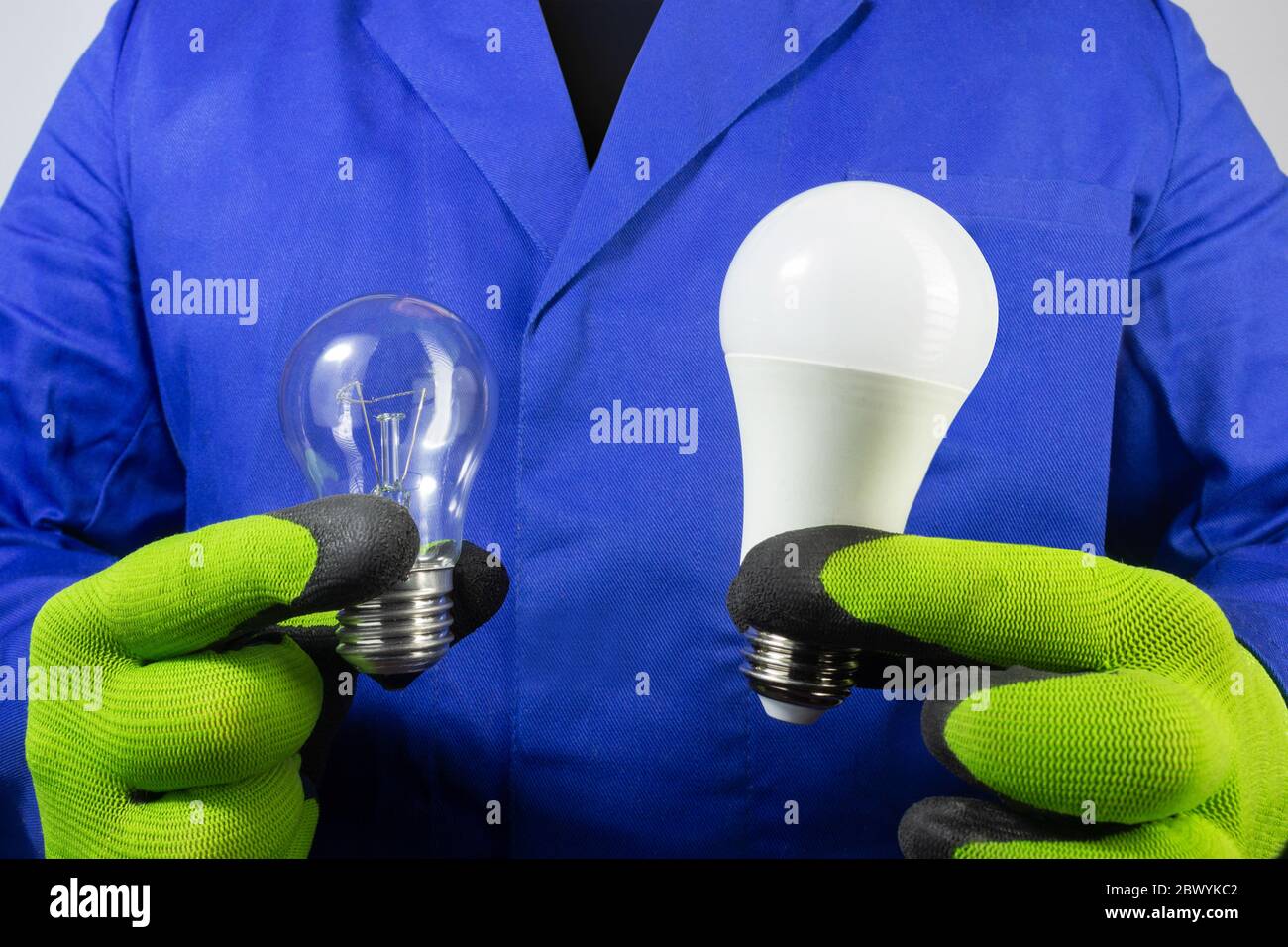Foto de electricista en bata azul y guantes que sostienen el viejo bilb y  la nueva luz LED de la vista de cerca Fotografía de stock - Alamy
