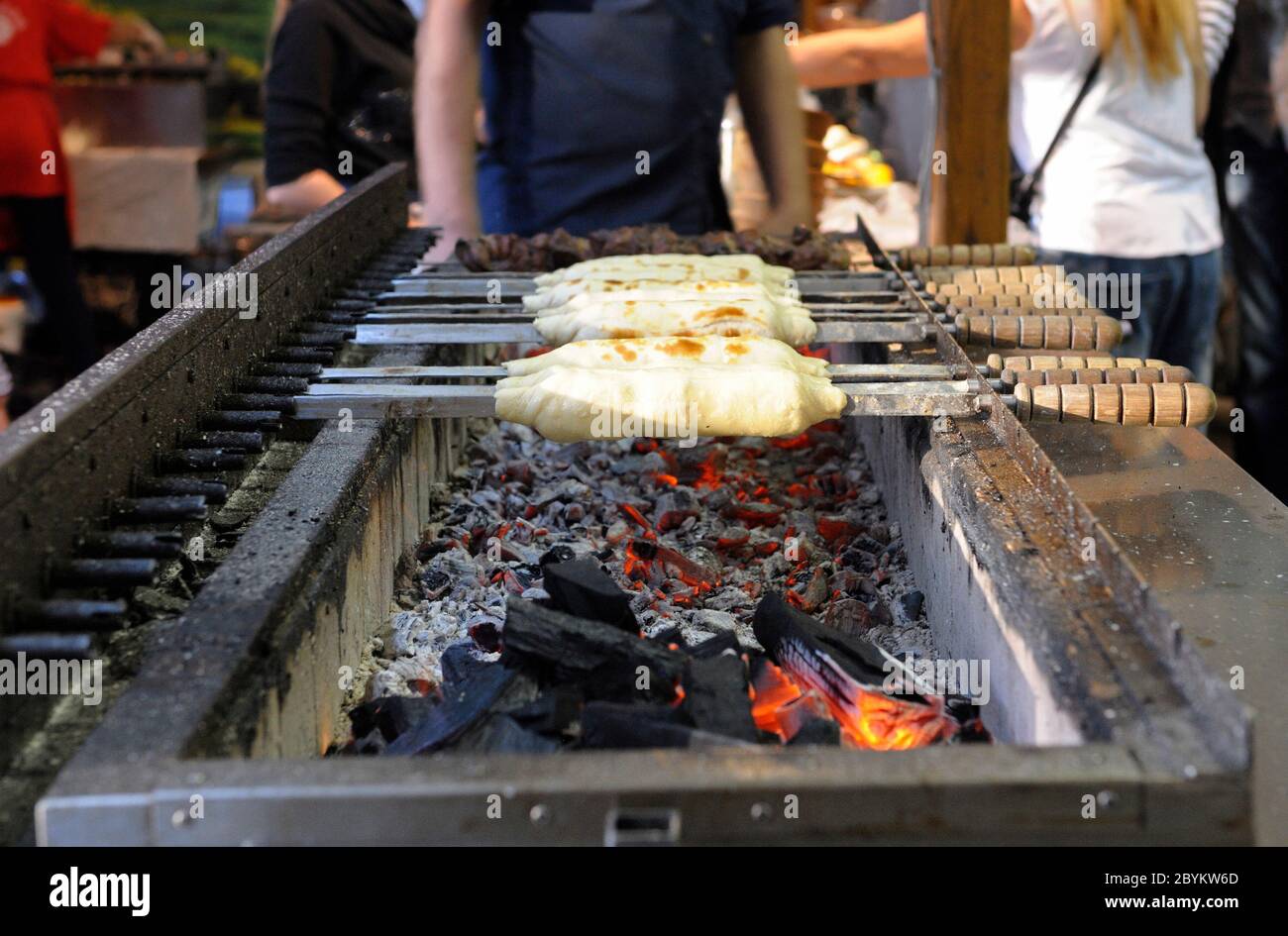 Freír barbacoa en una parrilla, gente de pie en el fondo Fotografía de  stock - Alamy
