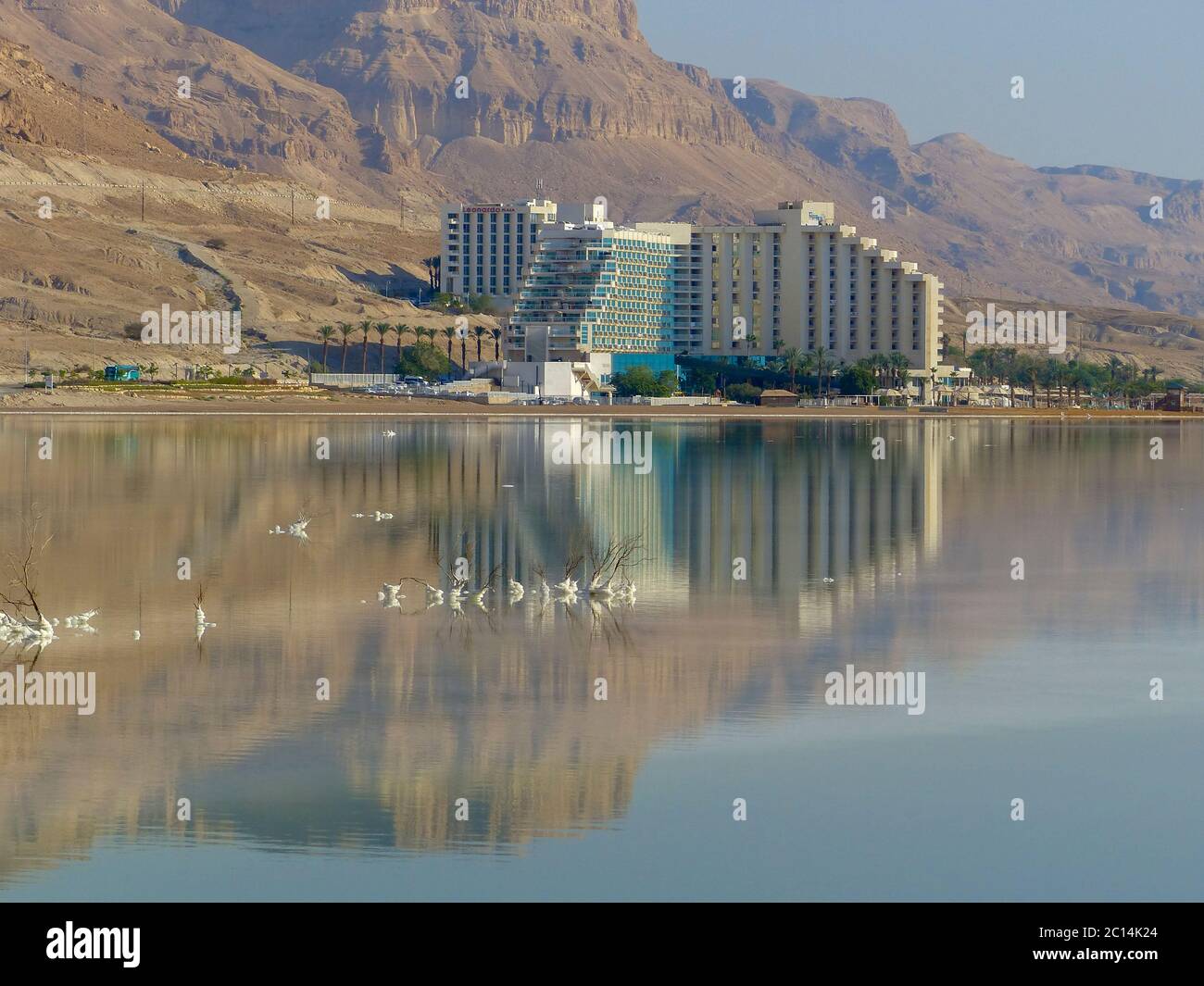Los hoteles, con reflexiones en el tranquilo y tranquilo agua del Mar muerto, Ein Bokek, Israel visto desde el sur Foto de stock