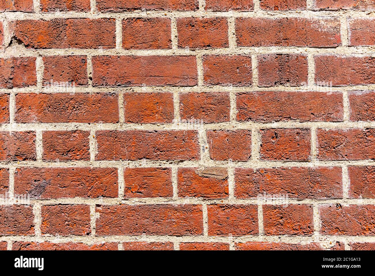 Fondo de una pared de ladrillo rojo profundo Foto de stock