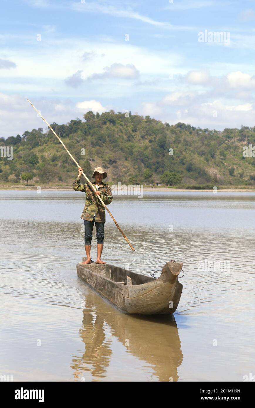 Dak Lak, Vietnam - 6 de enero de 2015 - El Hombre empujando un barco con un polo Foto de stock