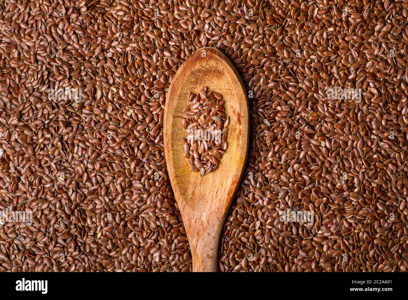 Primer plano de la semilla de lino en la cuchara de madera Foto de stock