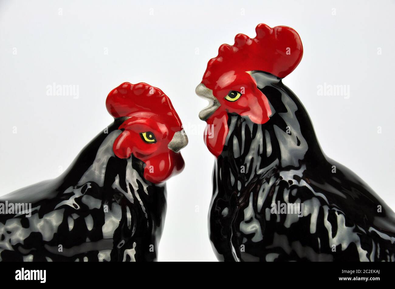 Un par de pollos de cerámica acristalados japoneses. Rooster y gallina discuten el matrimonio en el corral. "Deja de clucking conmigo." Excelente potencial meme. Foto de stock