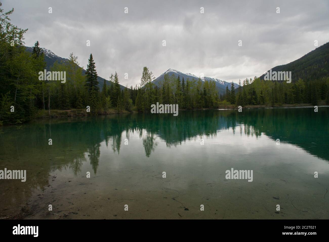 Paisaje escénico de un lago de montañas rocosas en Alberta, Canadá con clima lluvioso Foto de stock