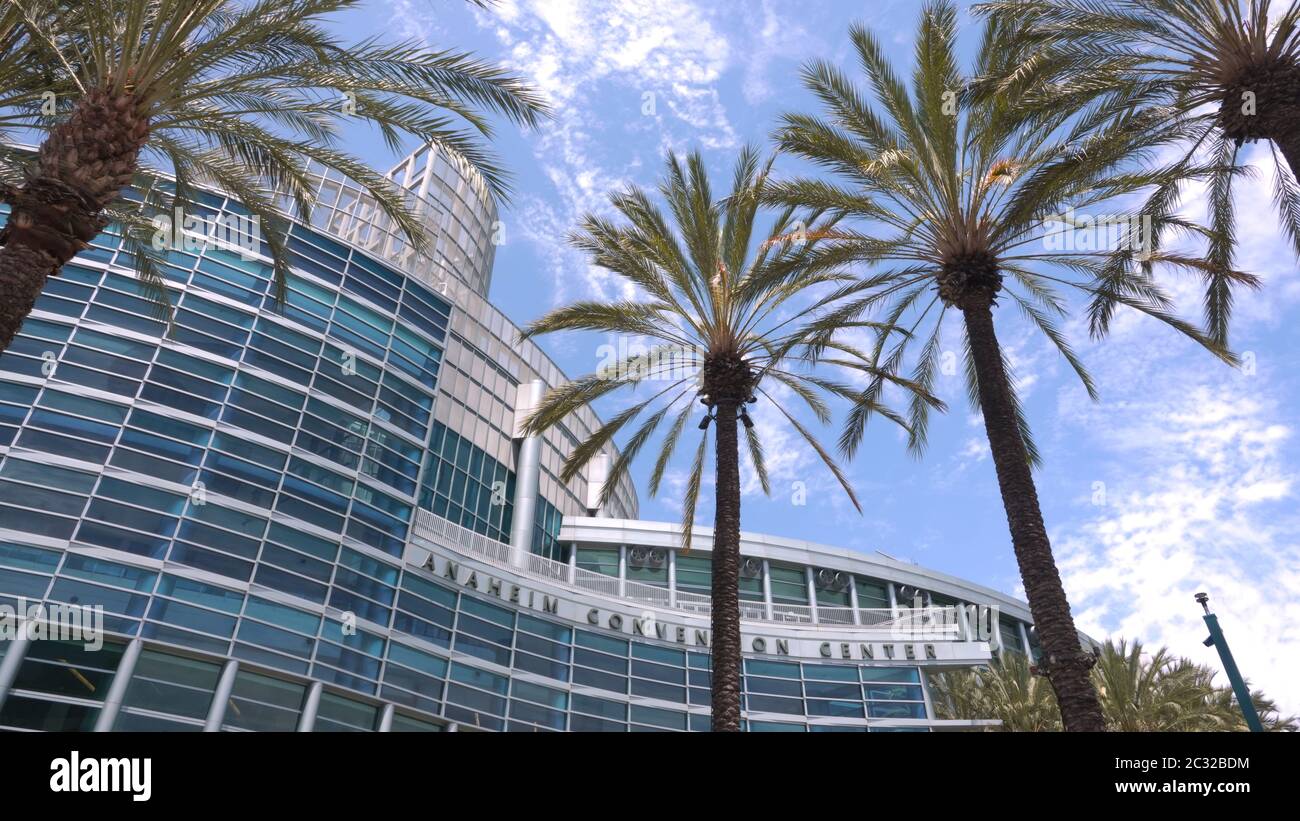Vista del Centro de Convenciones de Anaheim enmarcada por palmeras en un hermoso día soleado Foto de stock