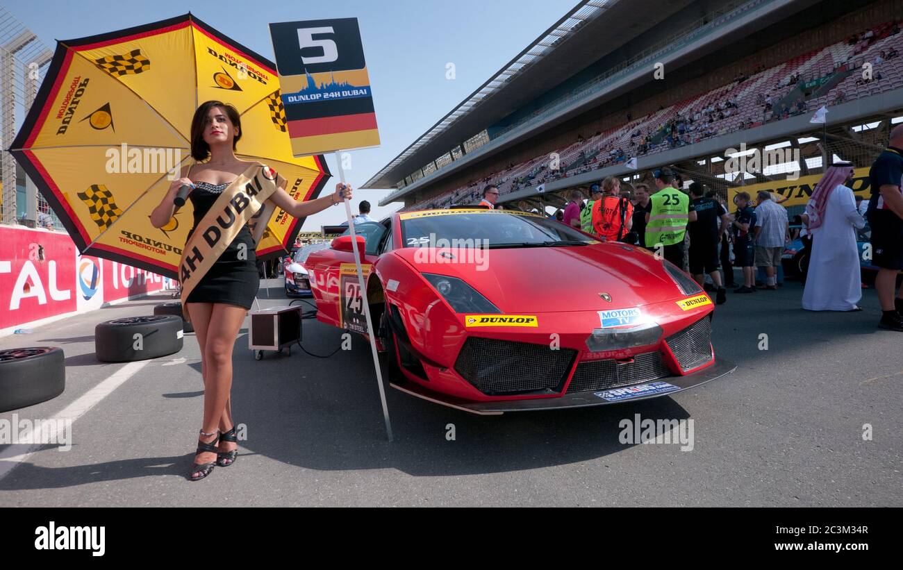 DUBAI - ENERO 13: Chica paraguas y Lamborghini Gallardo LP600 en la  parrilla de salida antes de