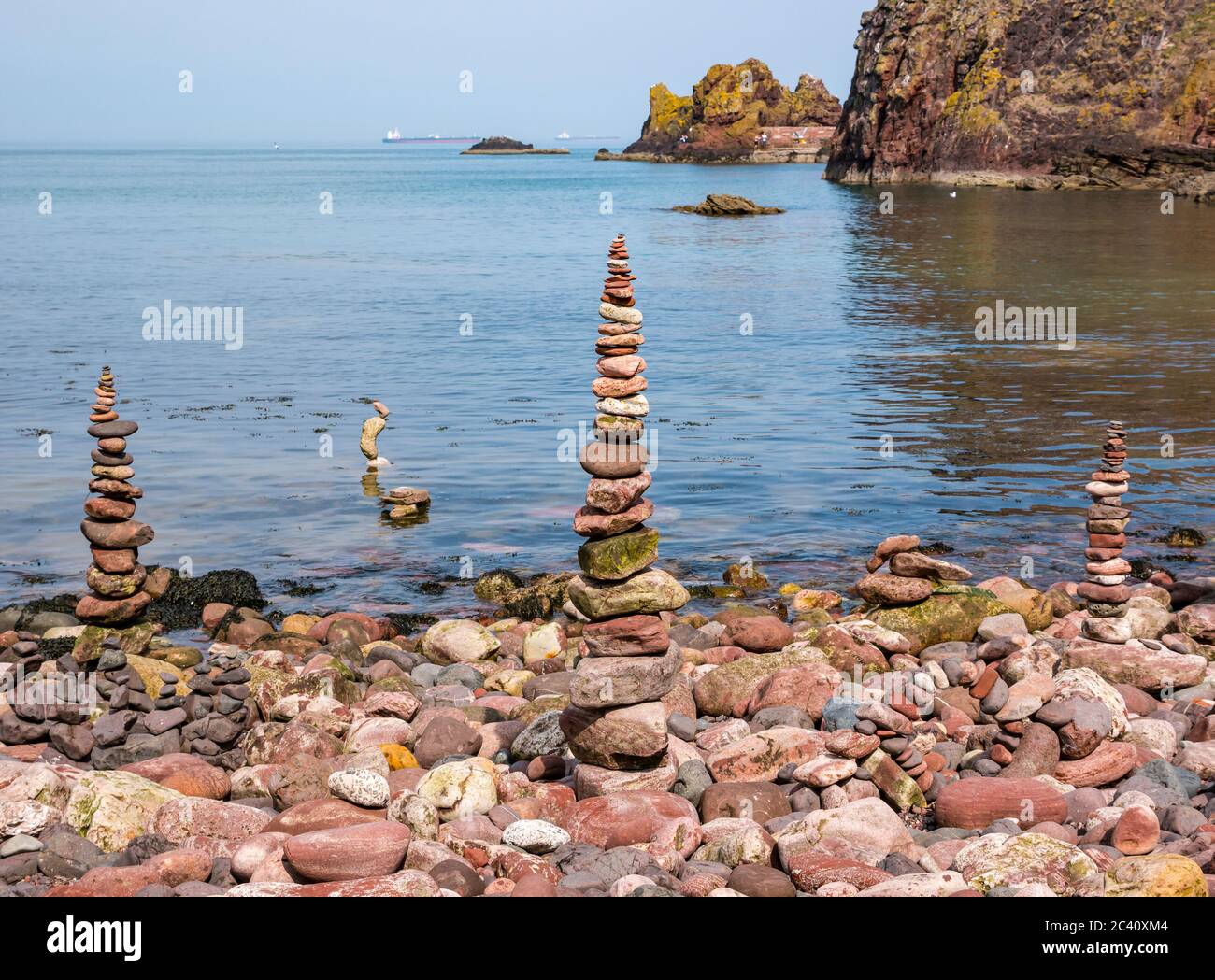 Piedras balanceadas con mar tranquilo, playa de Eye Cave, Dunbar, East Lothian, Escocia, Reino Unido Foto de stock