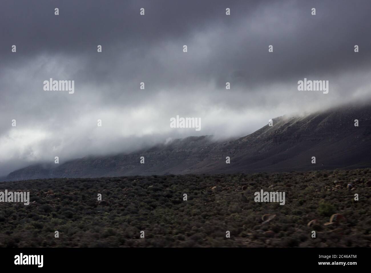 Nubes de nieve que vienen sobre las colinas, típico de la Nama Karoo, justo a las afueras de Sutherland, Sudáfrica Foto de stock