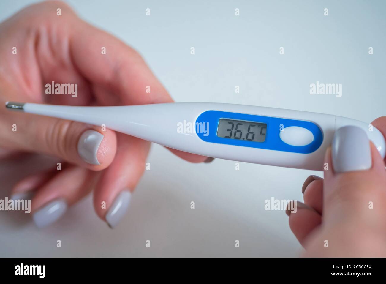 Manos de mujer mostrando termómetro médico digital con temperatura corporal  normal 36.6 - primer plano, enfoque selectivo. Salud, medición, enfermedad,  covid Fotografía de stock - Alamy