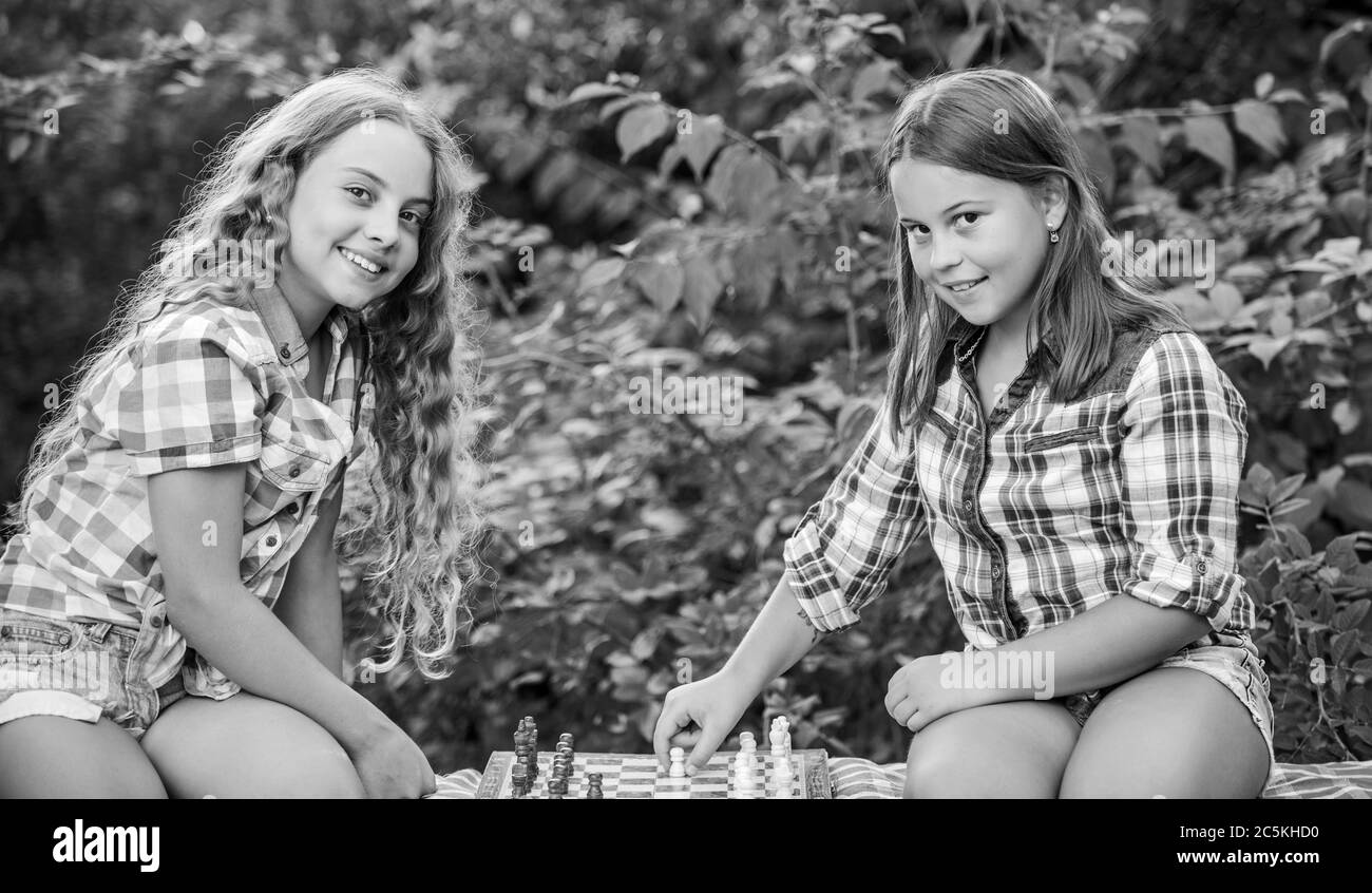Lluvia de ideas. Hacer que el cerebro funcione. El desarrollo de la primera infancia. dignos adversarios. Desarrollar habilidades ocultas. concentra las niñas juegan al ajedrez. juego de ajedrez hermanas niños calificados. Encienda su cerebro. Foto de stock