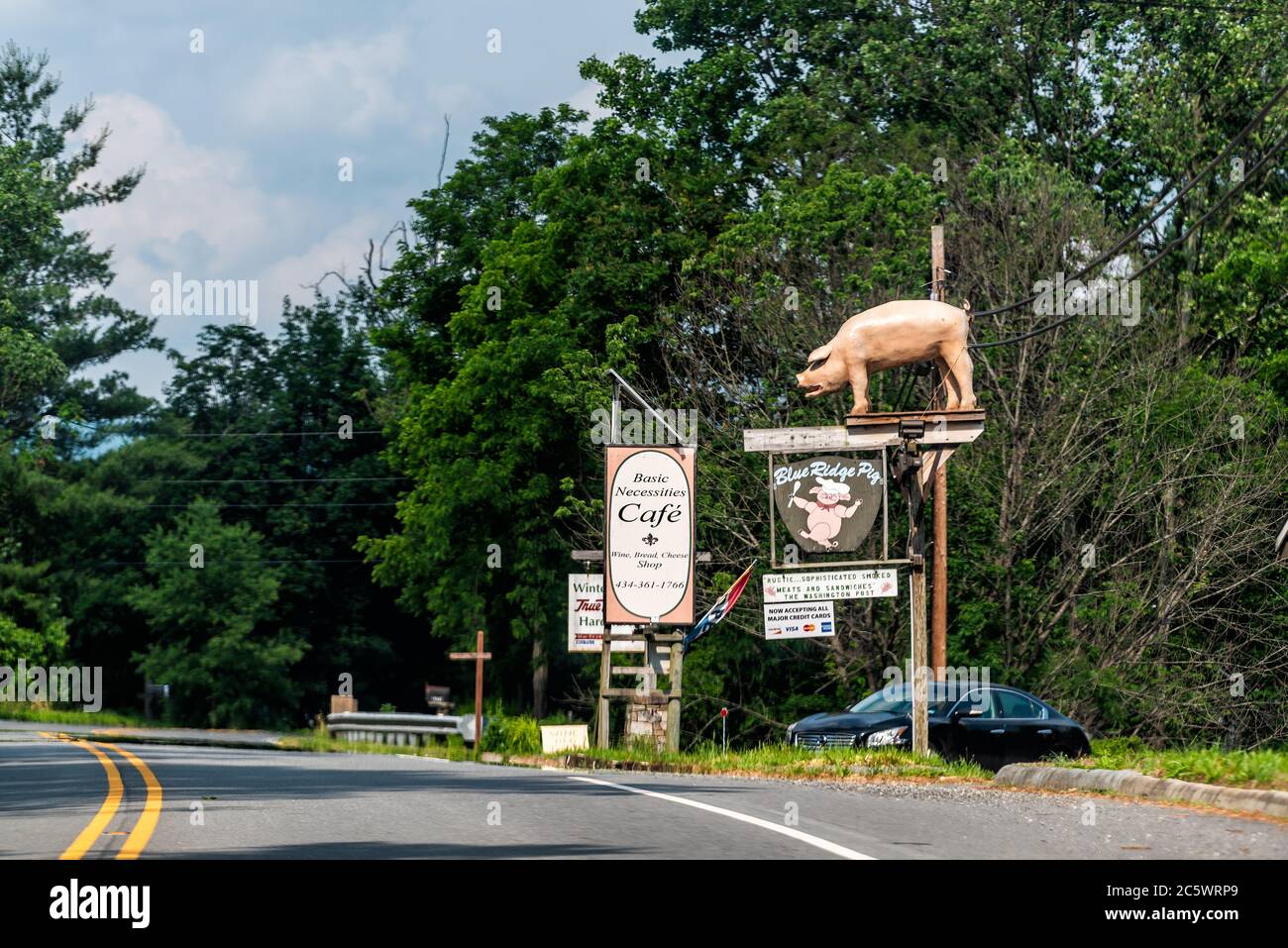 Nellysford, EE.UU. - 9 de junio de 2020: Nelson County, Virginia campo con señal de carretera para restaurante y tienda de Blue Ridge Pig y necesidades básicas Fr Foto de stock