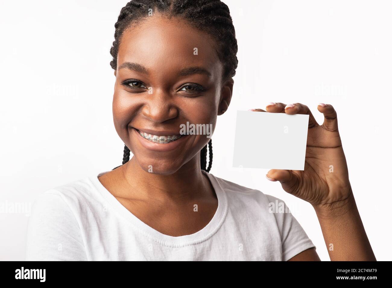 Mujer Negra en los cordones mostrando tarjeta visitante, fondo blanco, Mockup Foto de stock