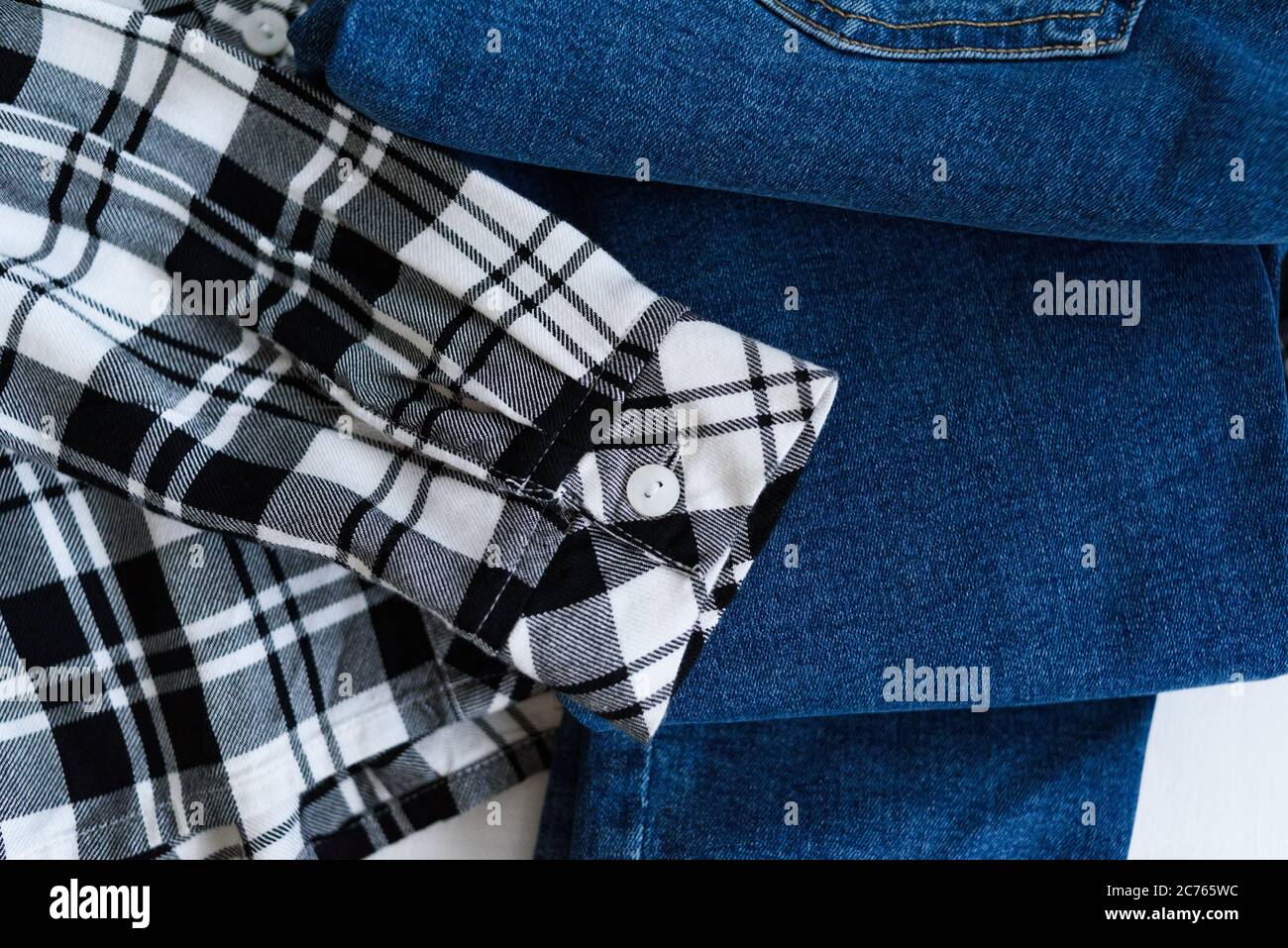 Concepto de ropa. Camisa de cuadros y jeans sobre fondo de madera. Detalles  Fotografía de stock - Alamy
