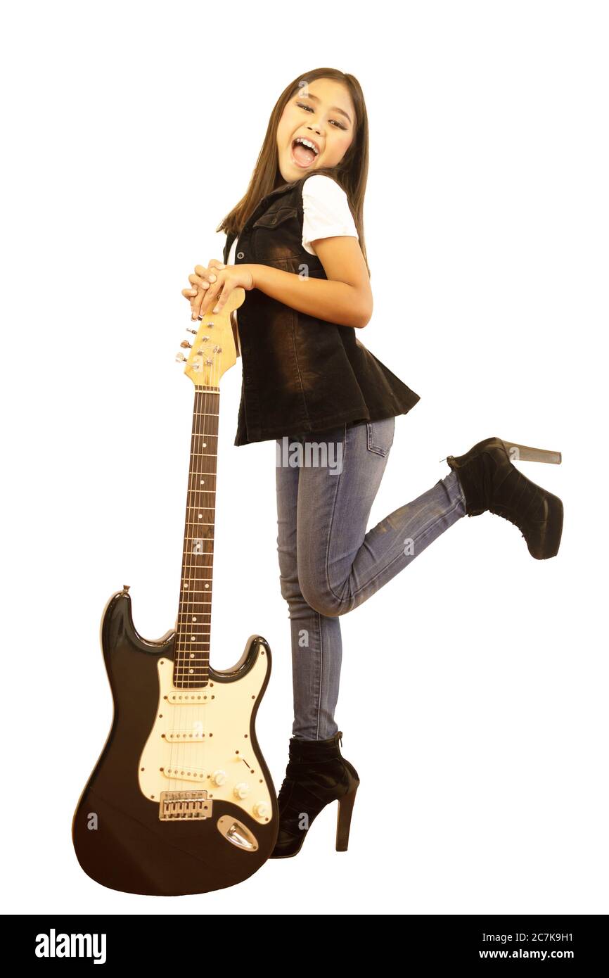 Un retrato de cuerpo entero de una linda chica de escuela asiática  elemental con una larga posando con una guitarra eléctrica. Una imagen  aislada con un backgroun blanco Fotografía de stock -