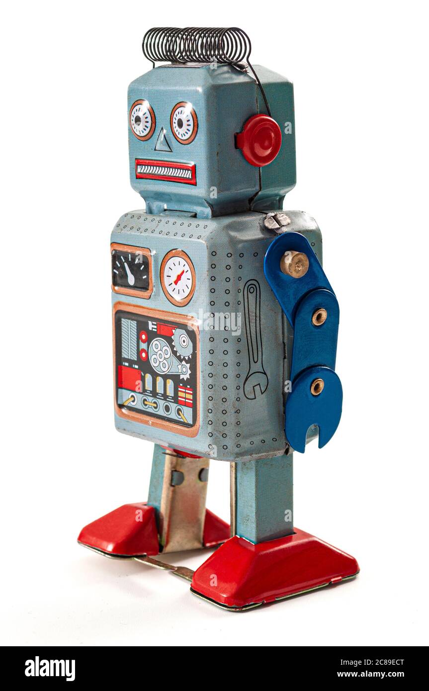 Antigua visión cifi del futuro, ciencia ficción nostalgia y juguete vintage idea conceptual con robot de metal azul retro aislado sobre fondo blanco ingenio Foto de stock