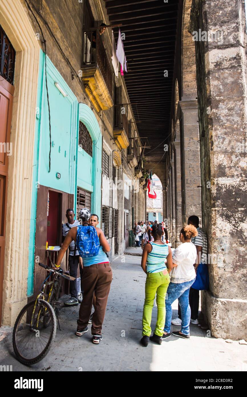 La Habana / Cuba - 04.15.2015: Hombres y mujeres cubanos de pie en la calle charlando Foto de stock