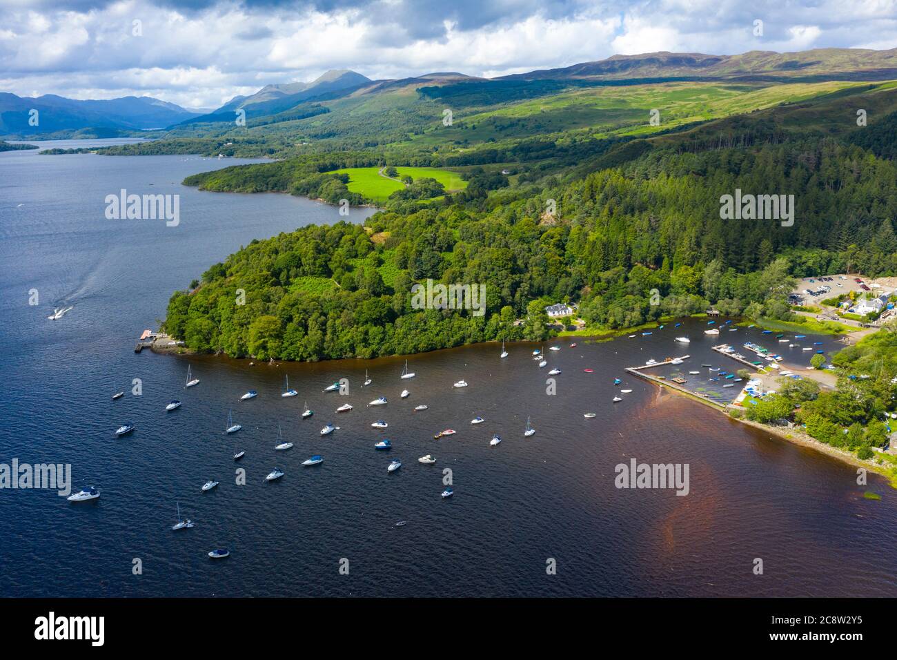 Vista aérea del pueblo de Balmaha a orillas del lago Lomond en el lago Lomond y el Parque Nacional Trossachs, Escocia, Reino Unido Foto de stock