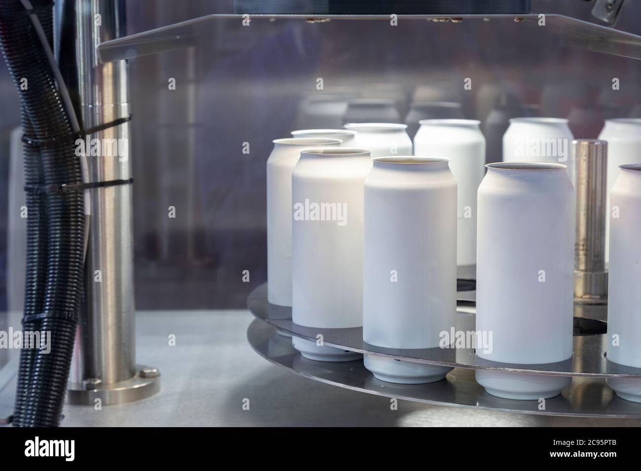 las nuevas latas de aluminio blanco vacías para el proceso de bebidas están escaneando y moviéndose en la línea de fábrica en la máquina de cinta transportadora en la fabricación de bebidas. alimentos y b Foto de stock
