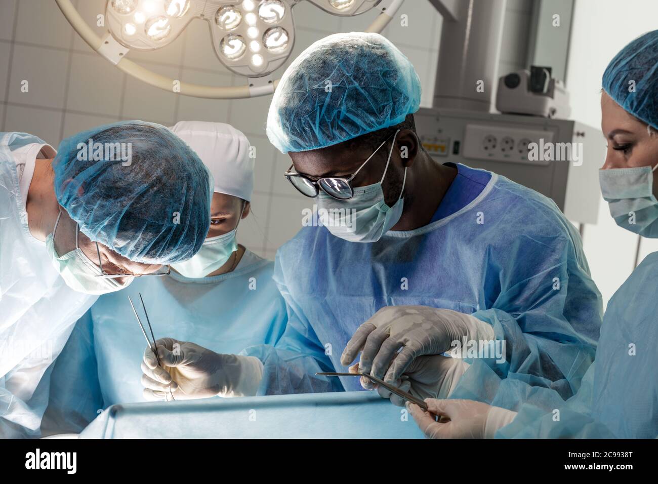 grupo de médicos exitosos mirando al paciente que está acostado en la