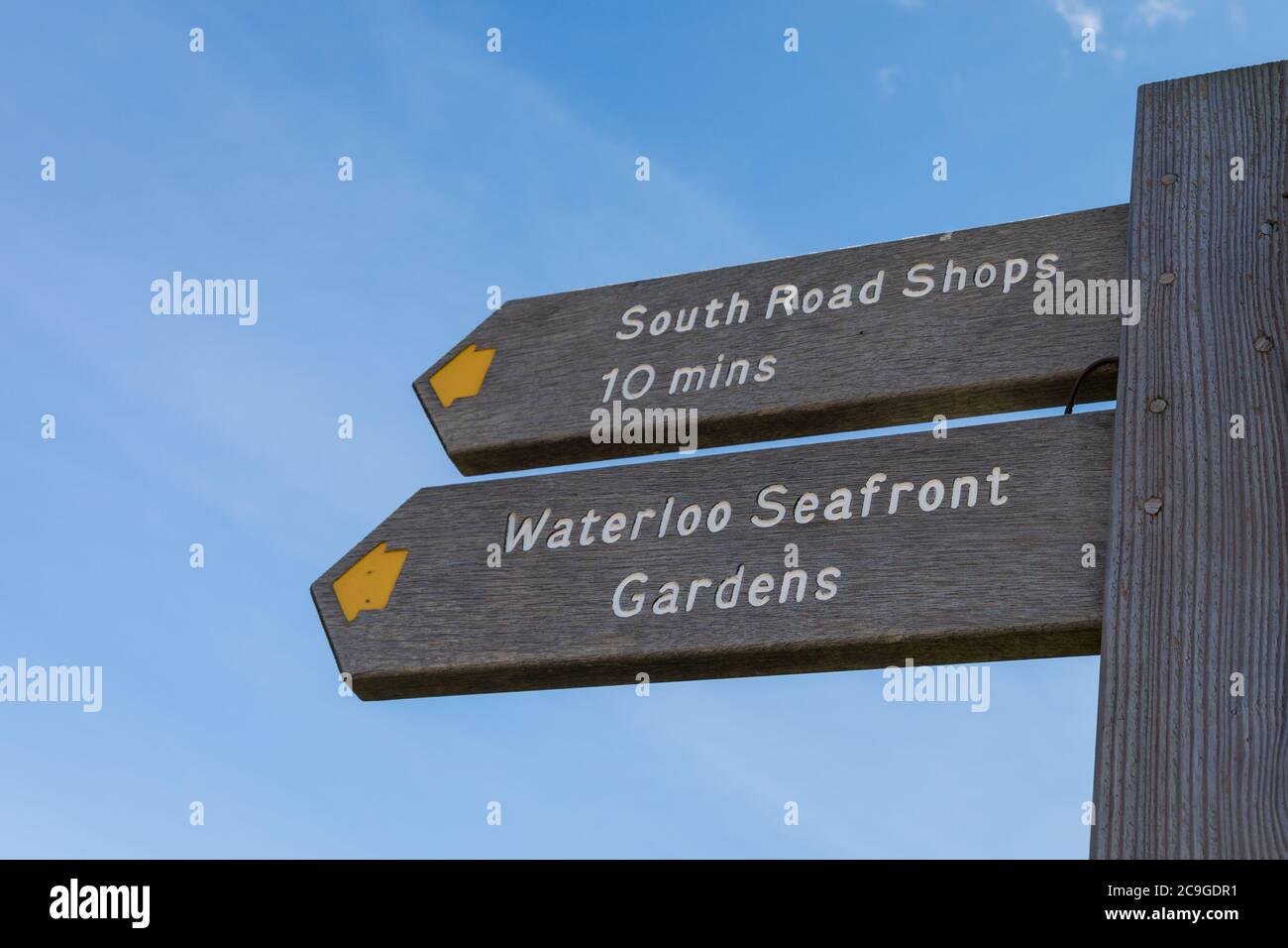 Una señal de madera que indica dirección a South Road Shops y Waterloo Seafront Gardens - Waterloo, Liverpool, Merseyside, UK Foto de stock