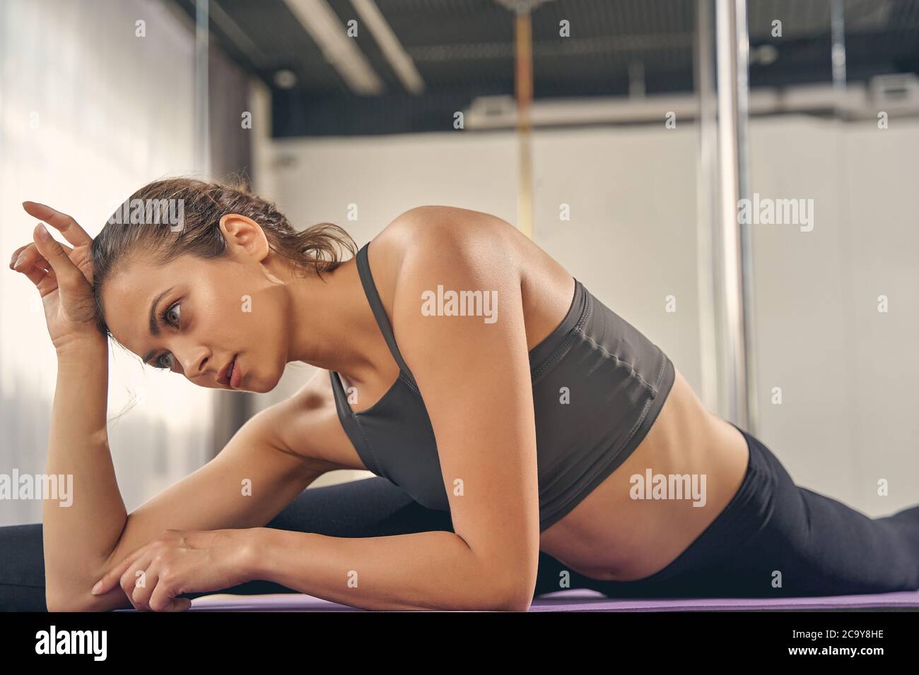 Encantadora mujer joven haciendo las divisiones en el estudio Foto de stock