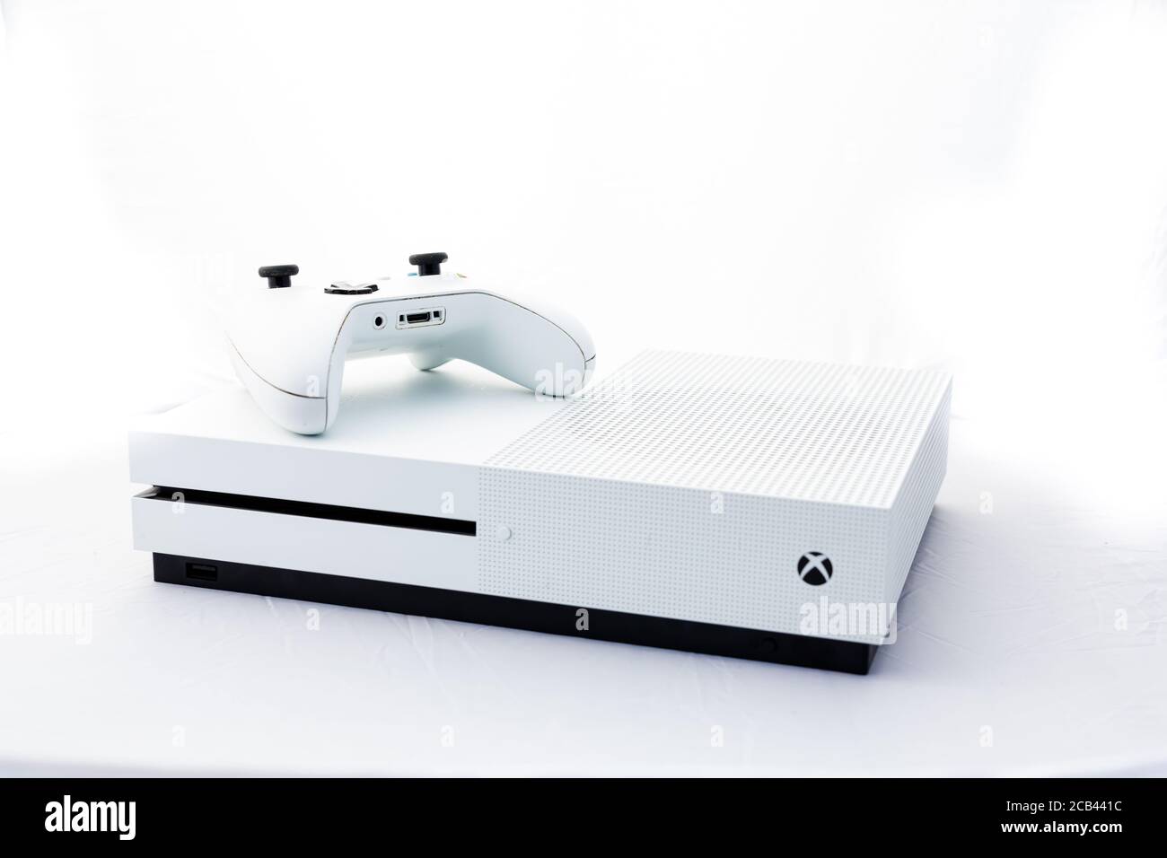 Suffolk, Reino Unido Junio 01 2020: Una consola de juegos Microsoft Xbox One S con un mando inalámbrico disparado contra un fondo blanco Foto de stock