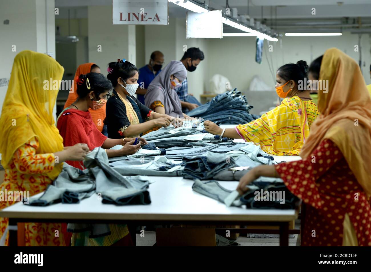 Dacca. 12 de agosto de 2020. La gente trabaja en una fábrica de ropa en  Dhaka, Bangladesh, el 12 de agosto de 2020. El ingreso de Bangladesh a las  exportaciones de julio