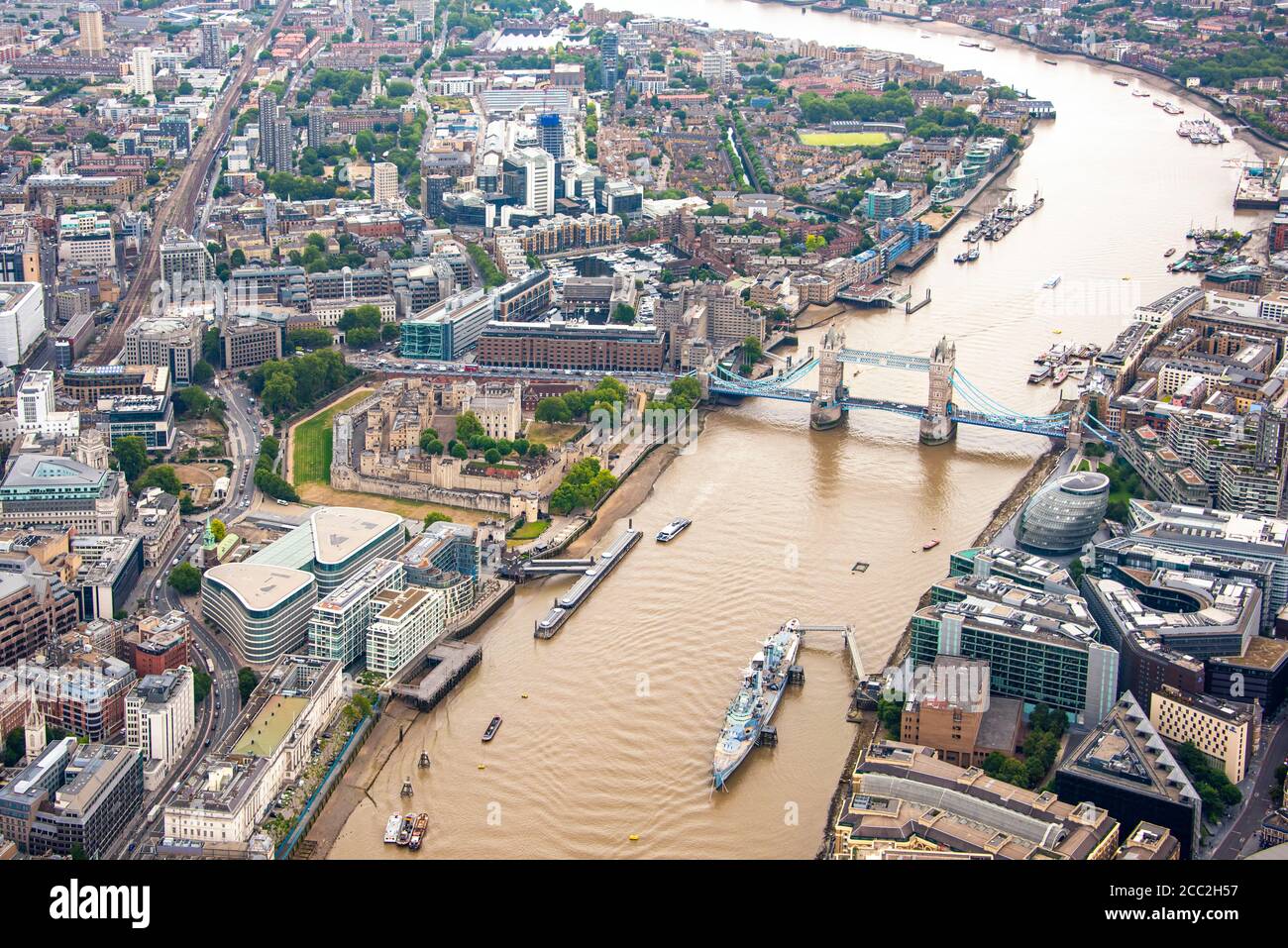 Vista aérea horizontal de HMS Belfast, Ayuntamiento, Torre de Londres y Tower Bridge mirando hacia el este de Londres. Foto de stock