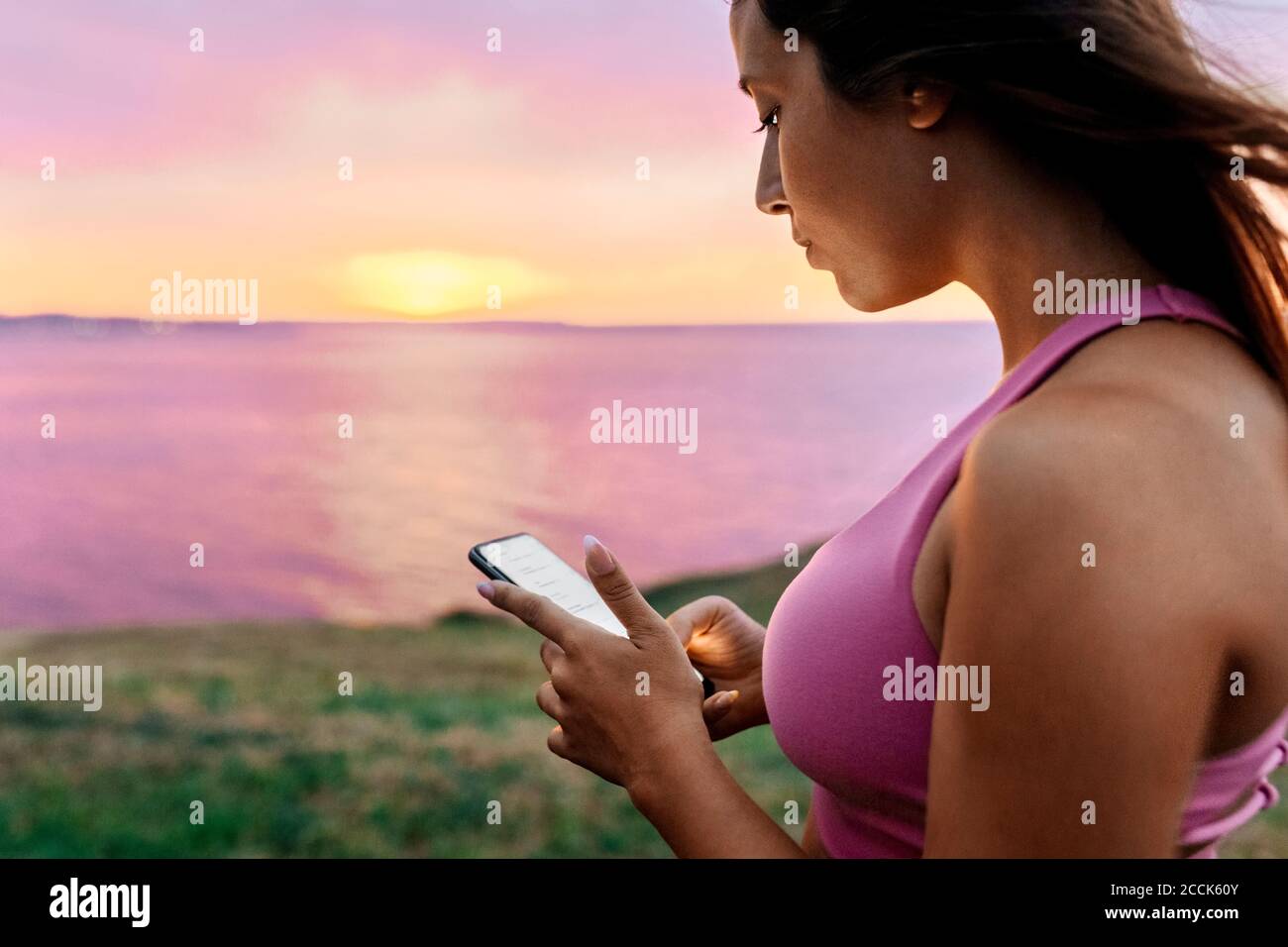 Mujer atleta usando el teléfono inteligente después de la actividad física Foto de stock