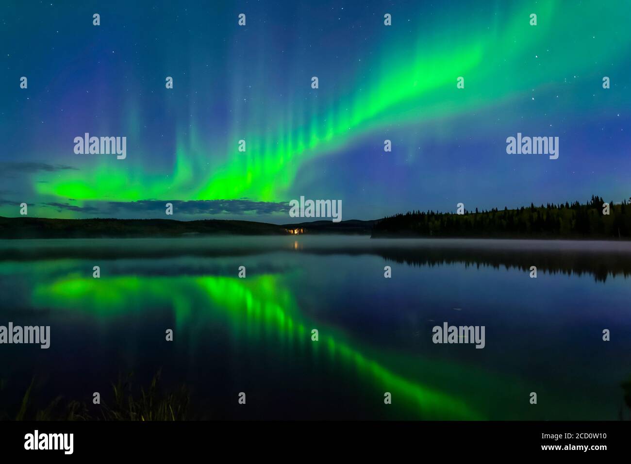 aurora verde brillante bailando sobre el lago Birch con reflexiones, Alaska interior en otoño; Fairbanks, Alaska, Estados Unidos de América Foto de stock