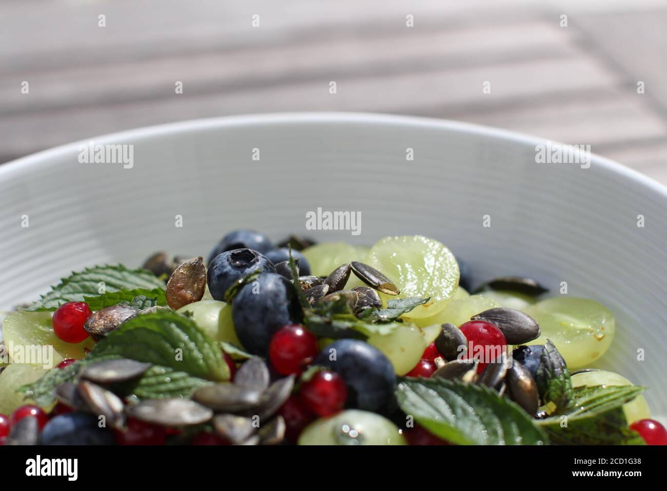 ensalada de frutas de colores con semillas de calabaza en la parte superior Foto de stock