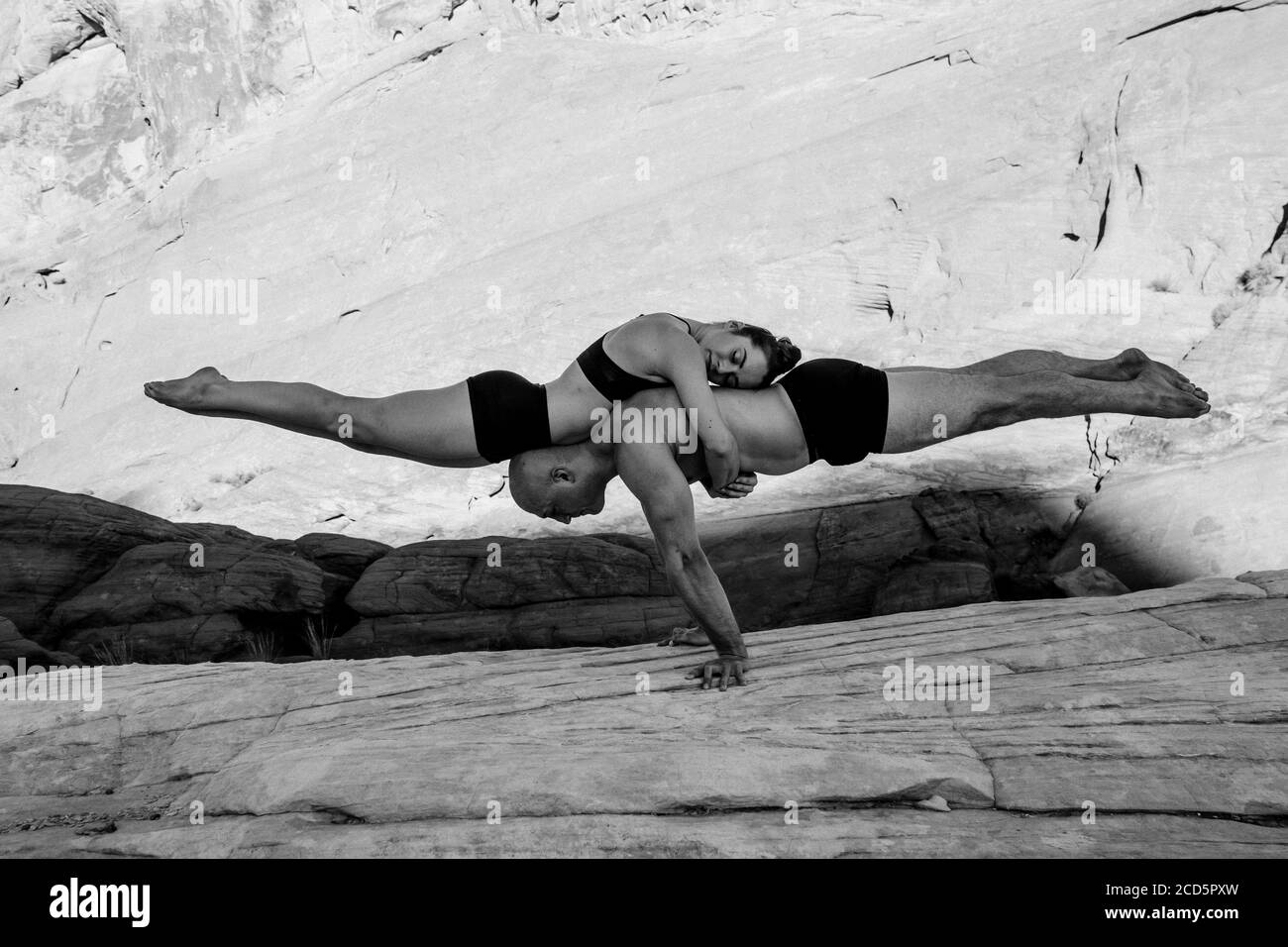 Pareja de gimnastas que equilibran en el desierto, Parque Estatal, Overton, Nevada, Estados Unidos Foto de stock