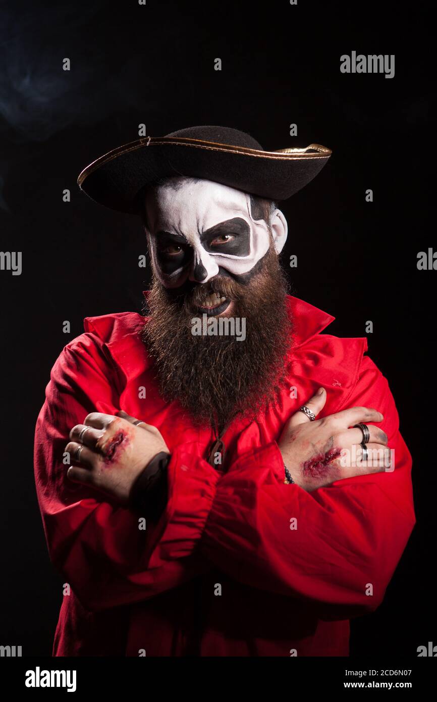 Hombre barbudo en traje pirata con maquillaje espeluznante sobre fondo  negro para halloween Fotografía de stock - Alamy