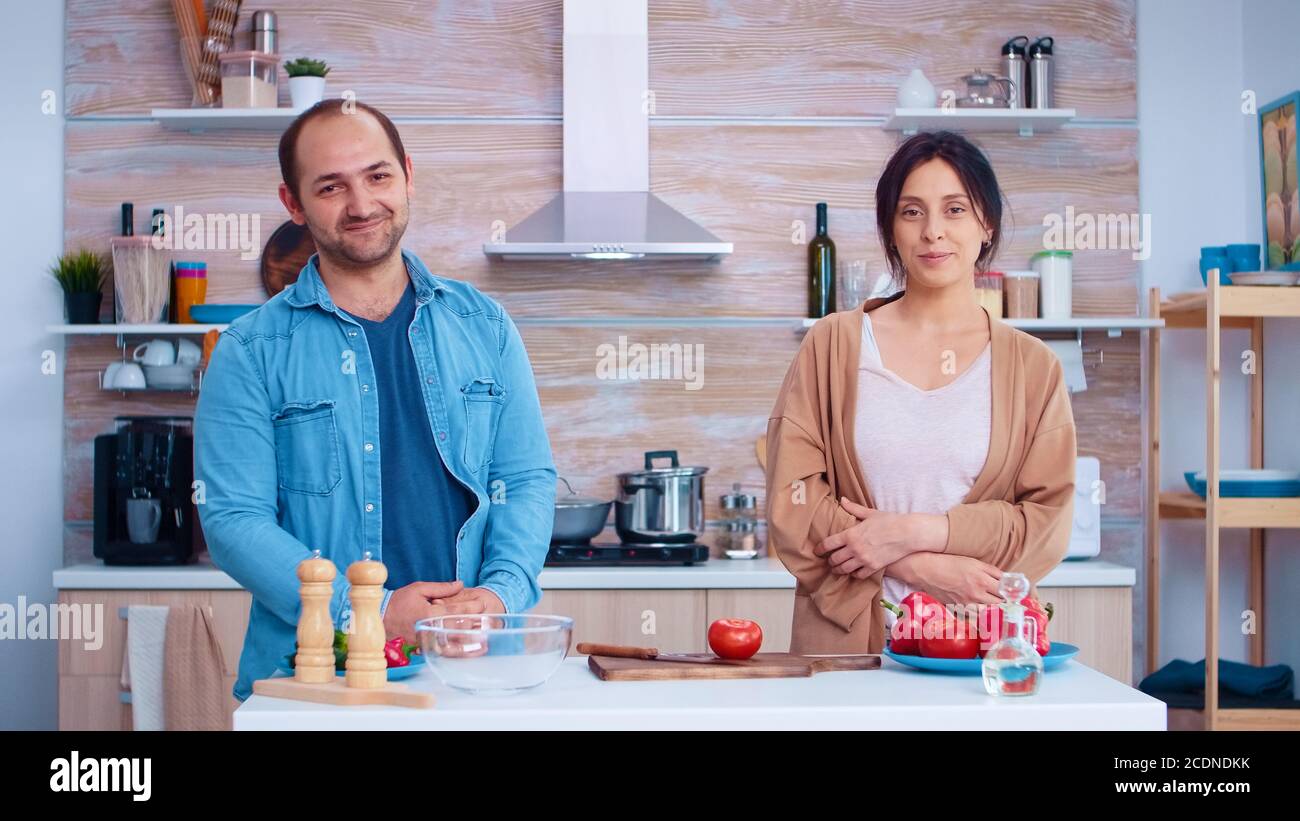 Felices Parejas Mirando La Cámara En La Cocina Y Verduras Para La Ensalada Cocina Preparar