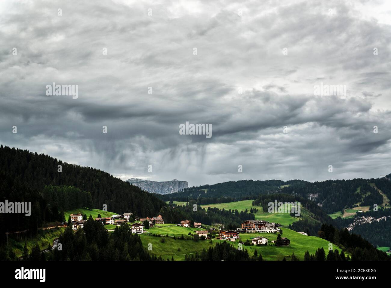 Nubes de tormenta sobre el pequeño pueblo de Gardena Valley, Alto Adige, Italia Foto de stock