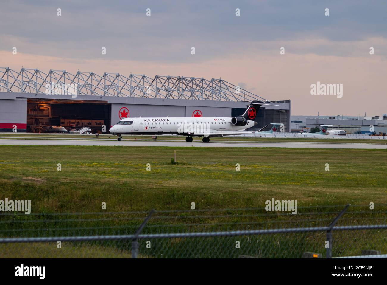 montreal, Quebec / Canadá - 07/02-2020 : Air Canada Express (Jazz) CRJ900 aterrizando en el aeropuerto internacional de Montreals en una noche nublada. Foto de stock